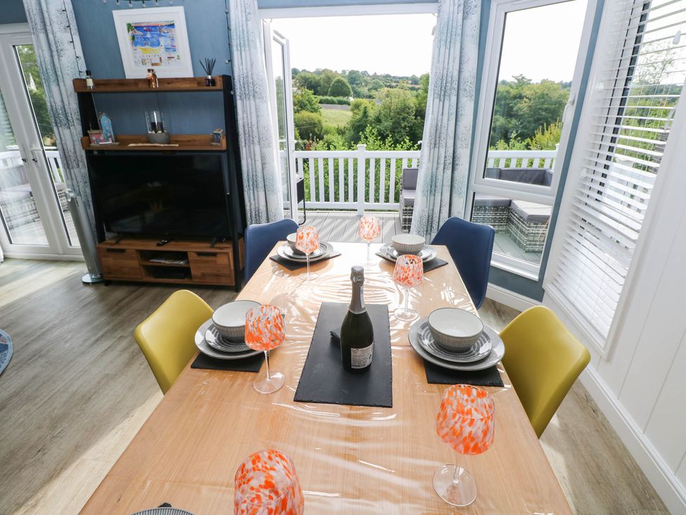 A dining room with a table set for a meal at Pleasant Valley Holiday Lodge 70 Stepaside