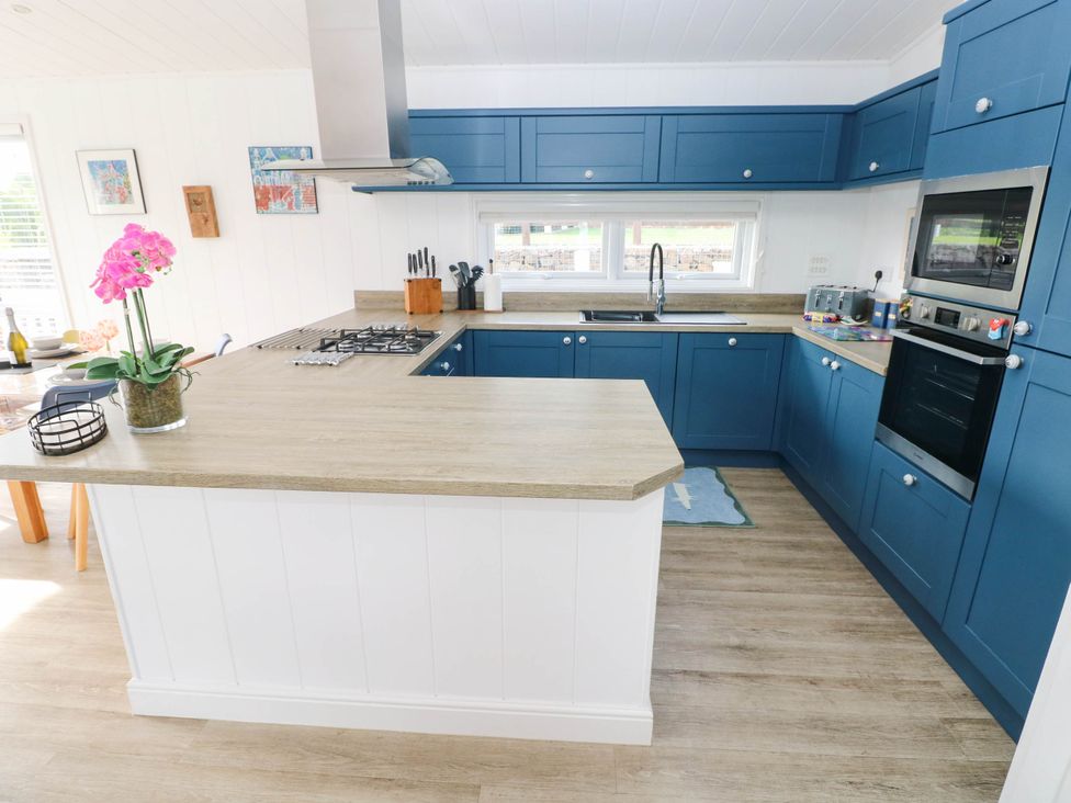 A kitchen with blue cabinets and a countertop at Pleasant Valley Holiday Lodge 70 Stepaside