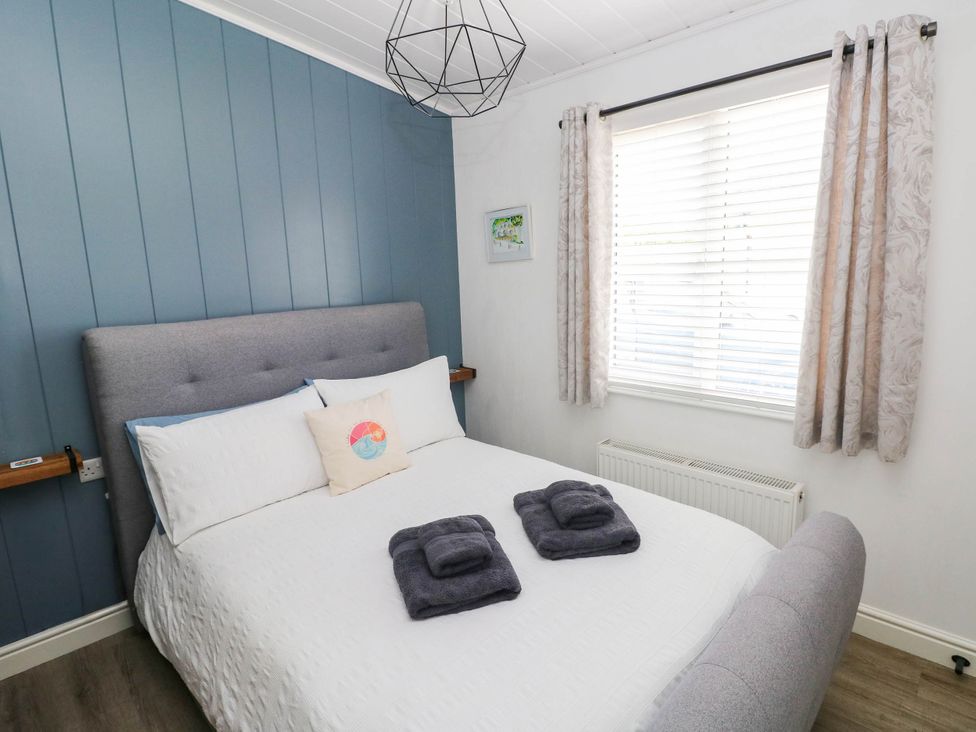 A bedroom with a bed and window at Pleasant Valley Holiday Lodge 70 Stepaside
