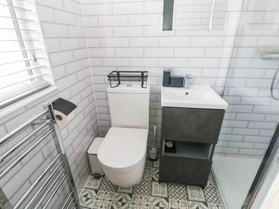 A bathroom with a toilet and sink at Pleasant Valley Holiday Lodge 70 Stepaside