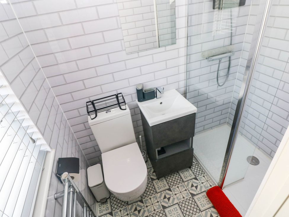 A bathroom with a toilet, sink, and shower at Pleasant Valley Holiday Lodge 70 Stepaside