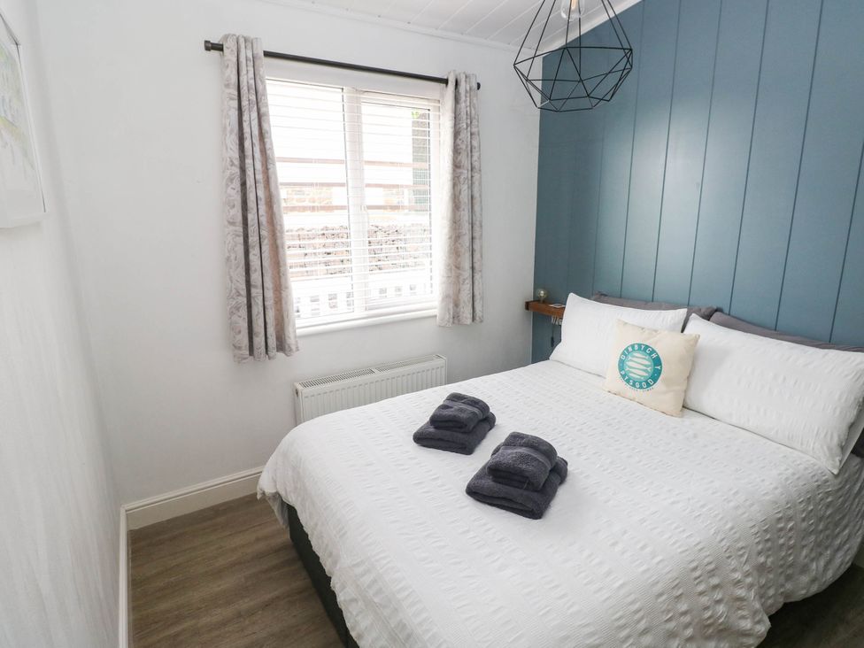A bedroom with a bed and towels at Pleasant Valley Holiday Lodge 70 Stepaside
