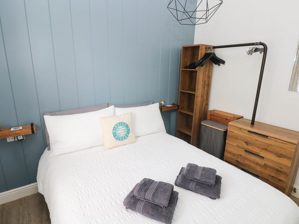 A bedroom with a bed and a clothes rack at Pleasant Valley Holiday Lodge 70 Stepaside