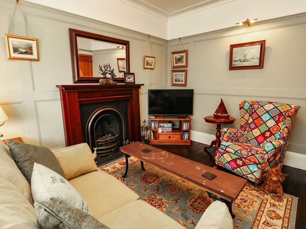 A living room with a fireplace and television at 11 Bryn Goleu Avenue North Holyhead