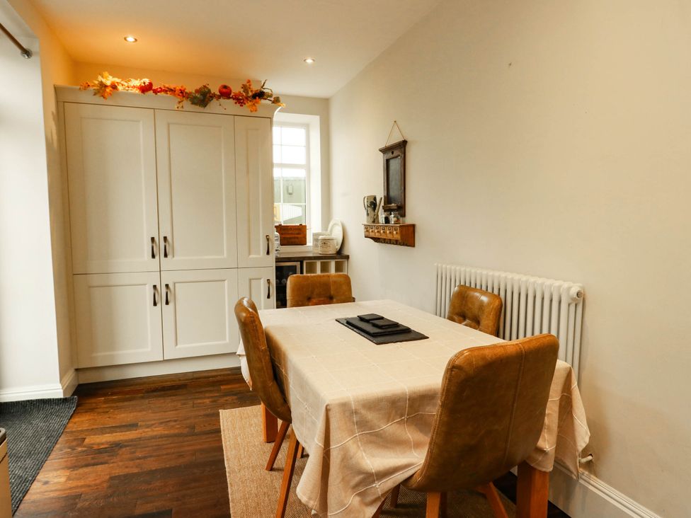 A dining room with a table and chairs at 11 Bryn Goleu Avenue North in Holyhead
