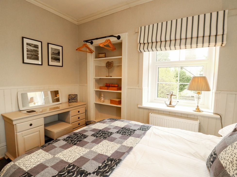 A bedroom with a bed, desk, and window at 11 Bryn Goleu Avenue North Holyhead