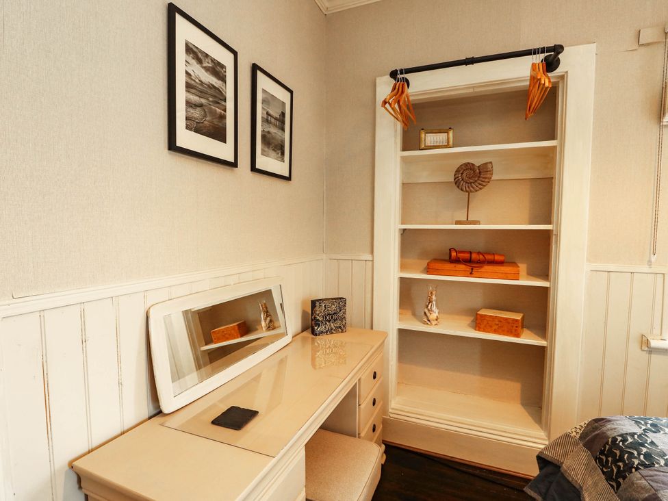 A bedroom with a desk and shelf at 11 Bryn Goleu Avenue North Holyhead