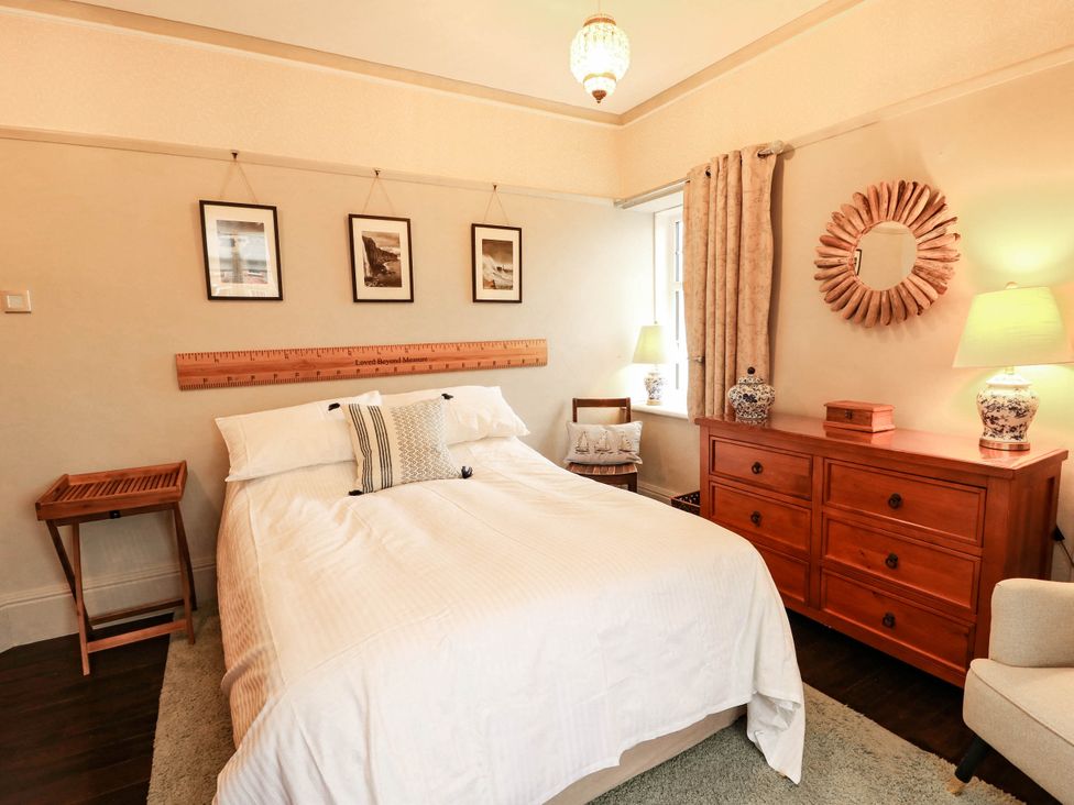 A bedroom with a bed and furniture at 11 Bryn Goleu Avenue North Holyhead