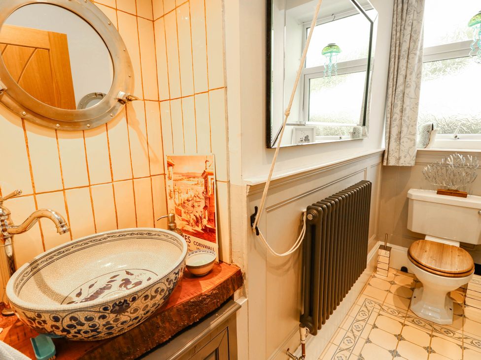 A bathroom with sink and toilet at 11 Bryn Goleu Avenue North in Holyhead
