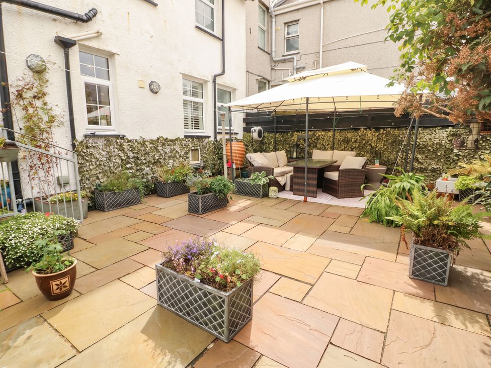A garden with seating area and planters at 11 Bryn Goleu Avenue North Holyhead