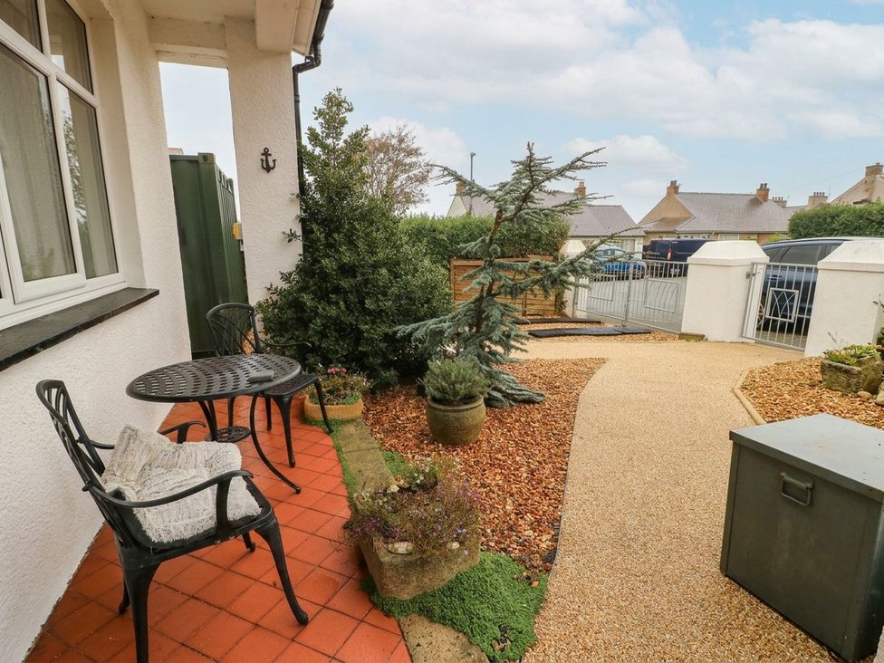 An outdoor seating area with a table and chairs at 11 Bryn Goleu Avenue North, Holyhead