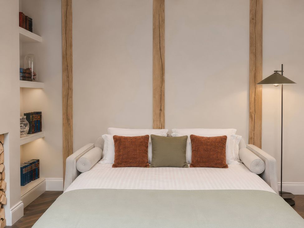 A bedroom with a bed and bookshelf at Apt. 2 in York