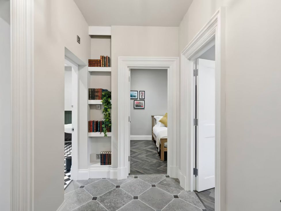 A hallway with bookshelves and doors at Apt. 2 in York