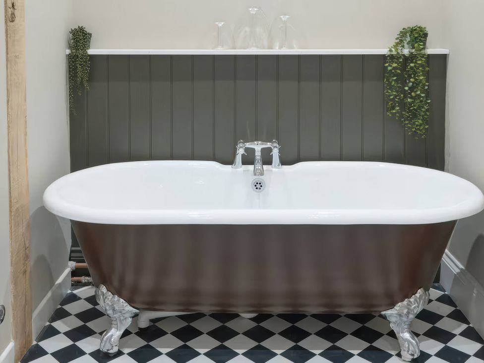 A bathroom with a bathtub and wall panels at Apt. 2 in York