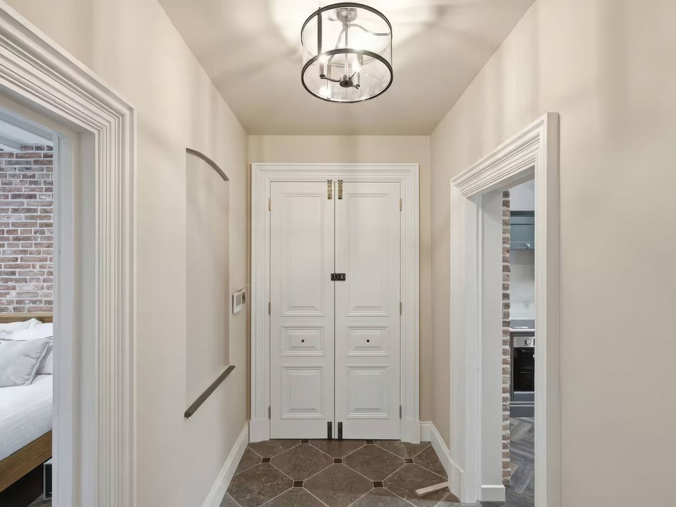 A hallway with a front door and light fixture at Apt. 2 in York