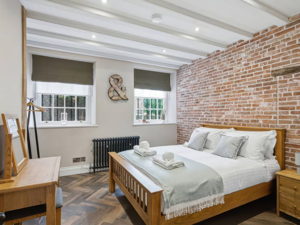 A bedroom with a bed and towels on a side table at Apt. 2 in York