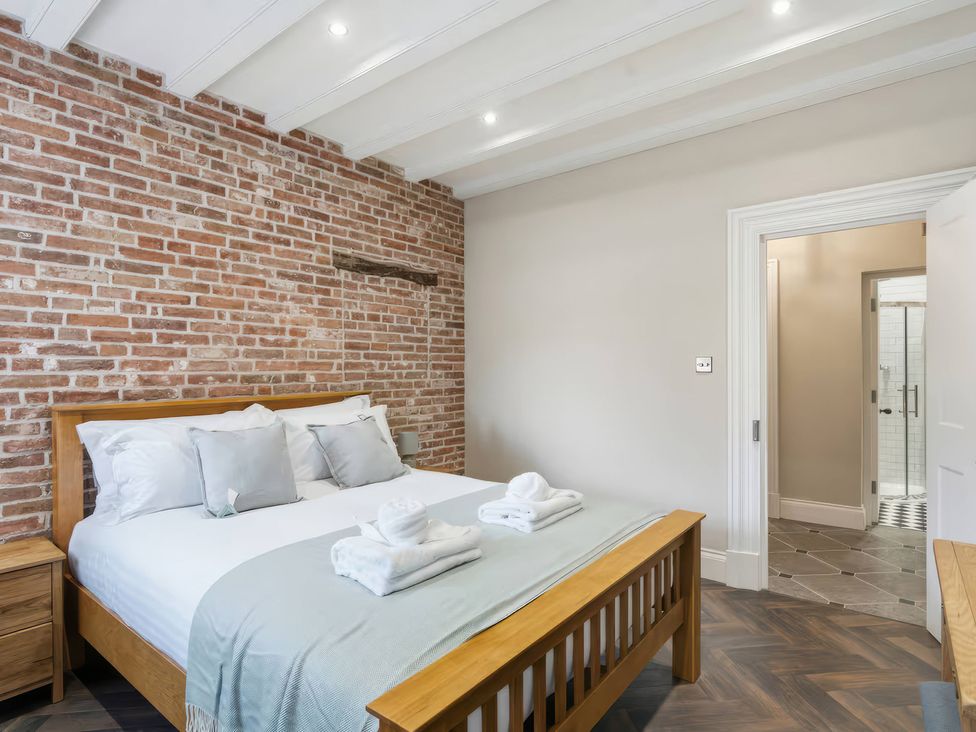 A bedroom with a bed and a doorway to a bathroom at Apt. 2 in York