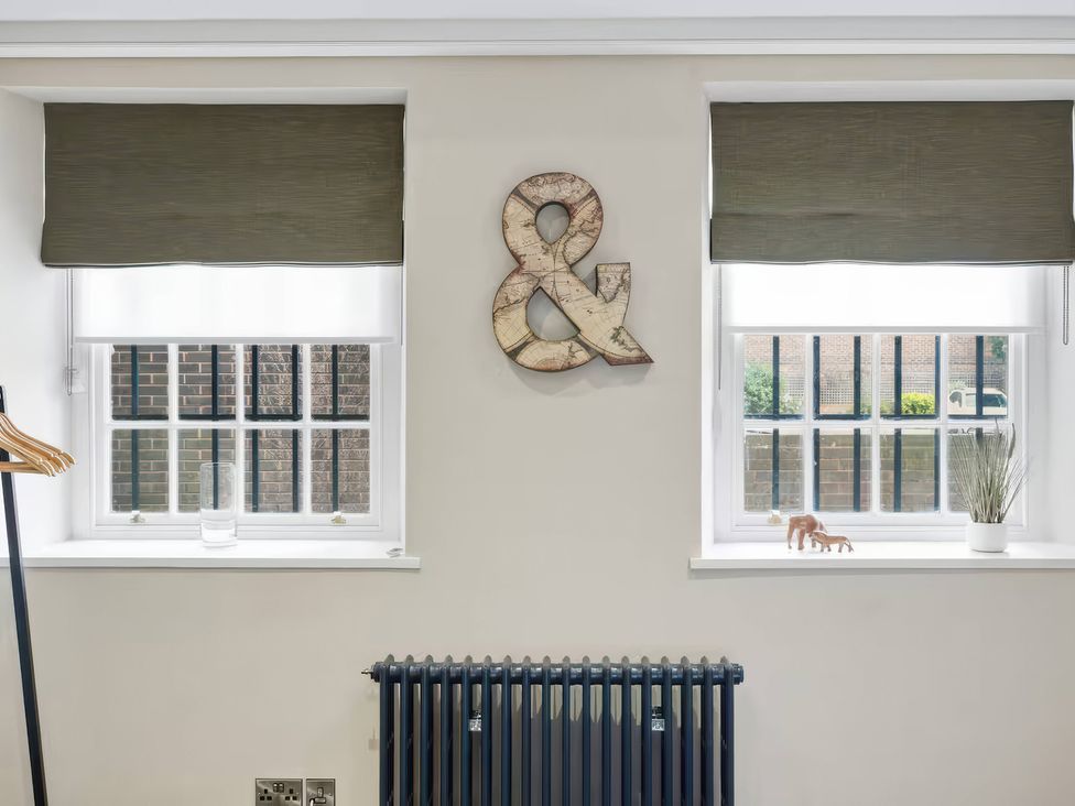 A room with windows and a decorative ampersand at Apt. 2 in York