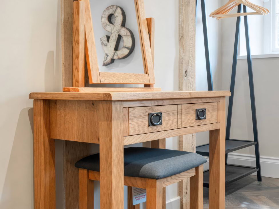 A desk with a mirror and chair in a dressing room at Apt. 2 York