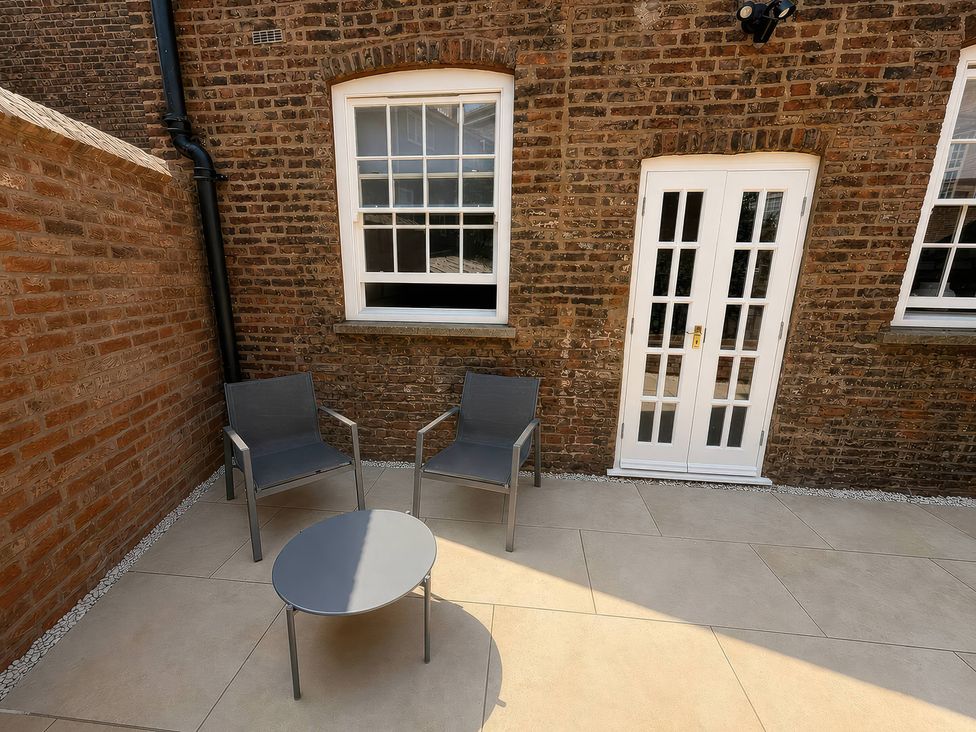 A patio area with two chairs and a table at Apt. 2 in York