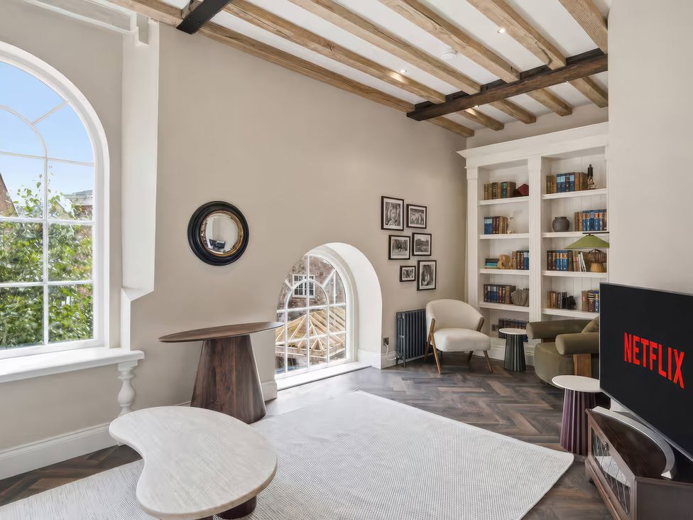 A living room with a television and bookshelves at Apt. 3 in York
