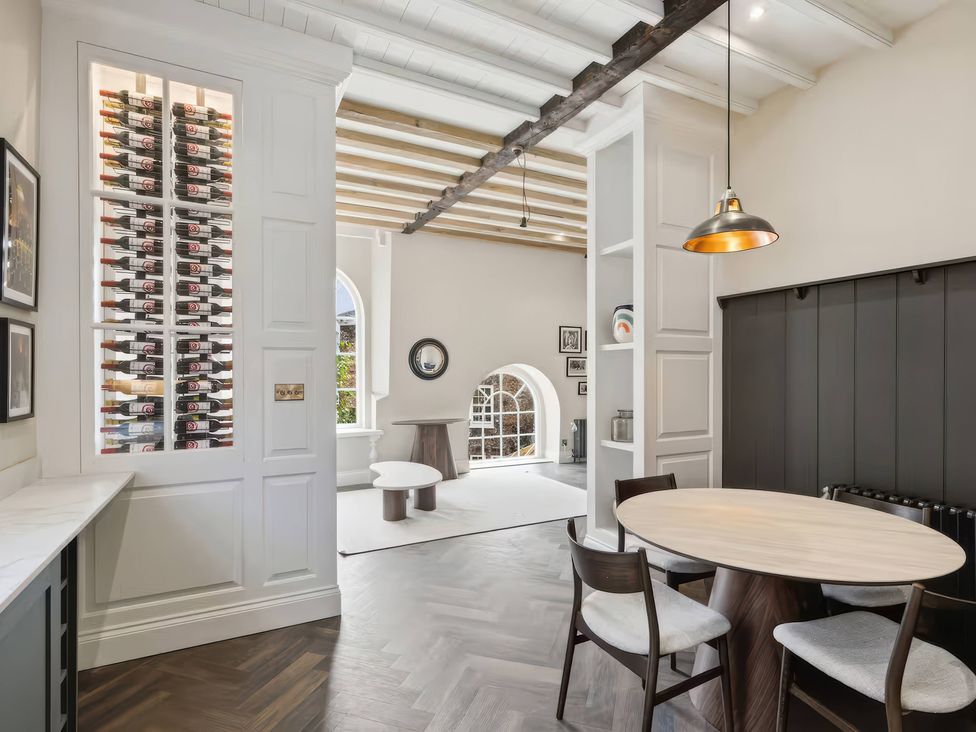 A dining room featuring a wine rack and a round table at Apt. 3 in York