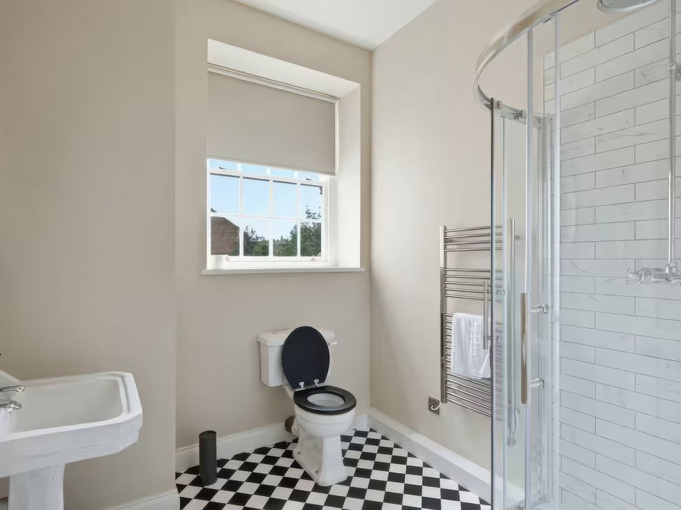 A bathroom with a toilet, sink, and shower at Apt. 3 in York