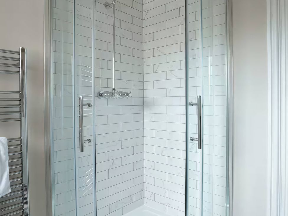 A shower with glass doors at Apt. 3 in York