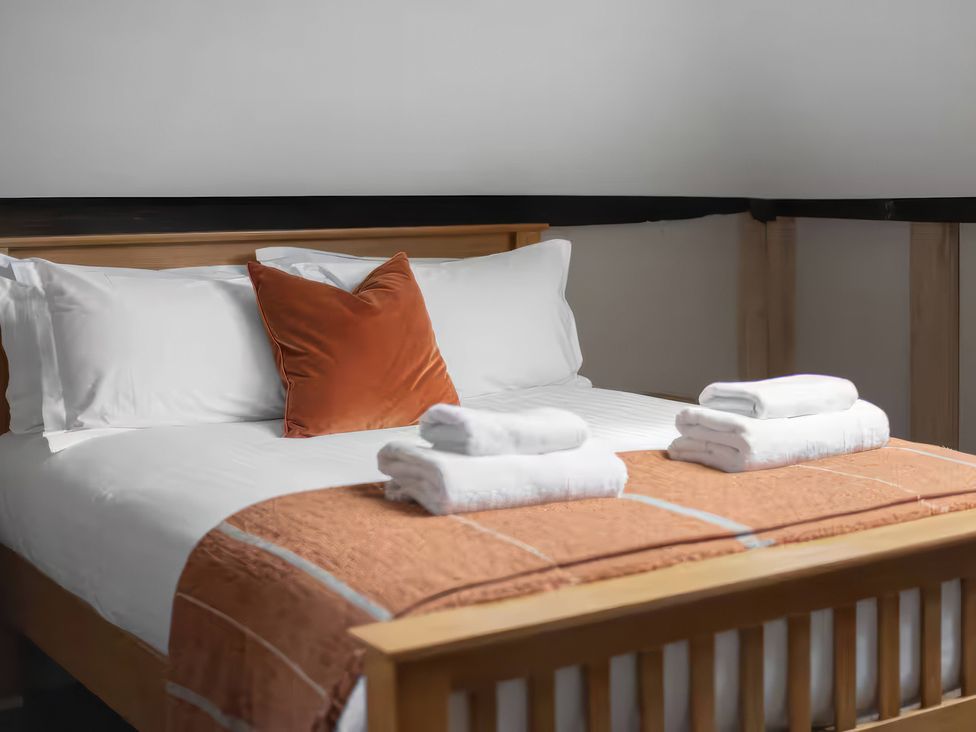 A bed with pillows and towels arranged at Apt. 3 in York