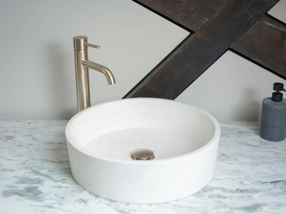 A sink with a tap and soap dispenser at Apt. 3 in York