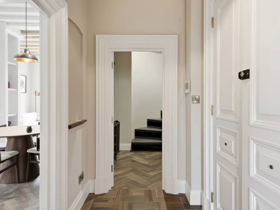 A hallway with a door and staircase at Apt. 3 in York