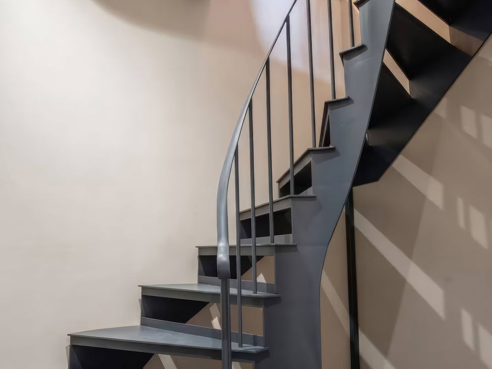 A spiral staircase with a railing at Apt. 3 in York