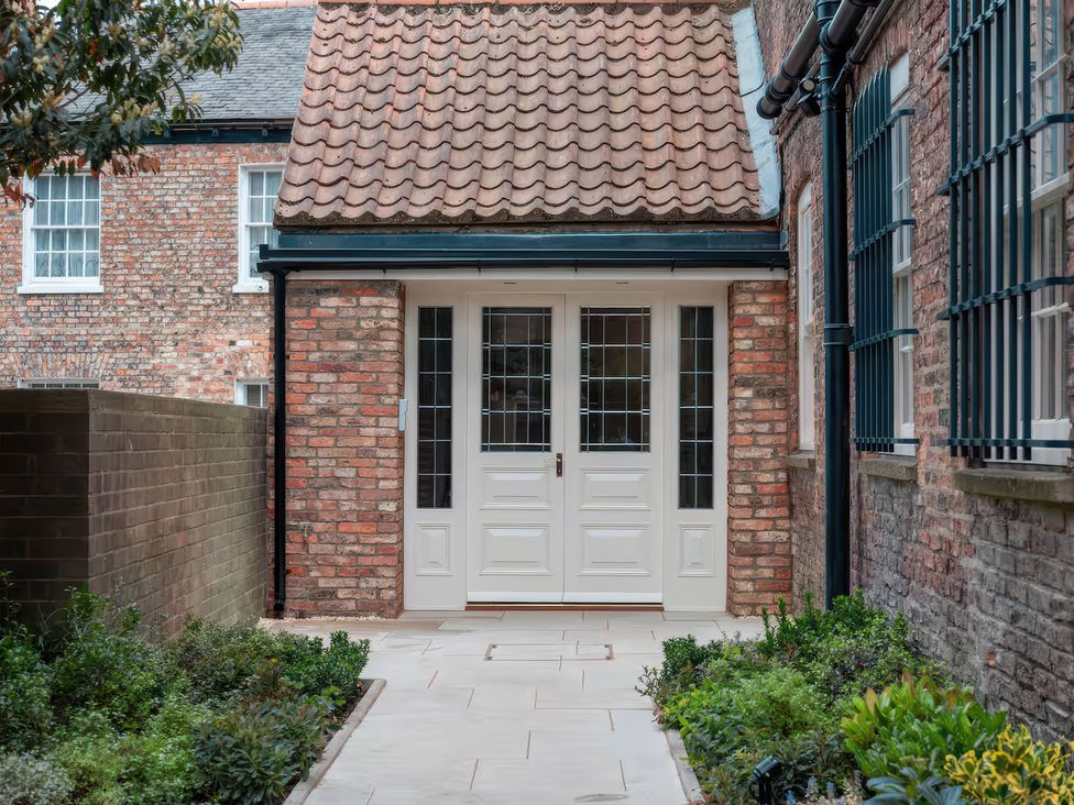An entrance with a door and plants at Apt. 3 in York