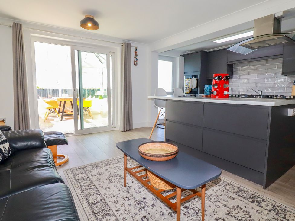 A living room with a coffee table and sofa at Mermaid Gaze in Newquay