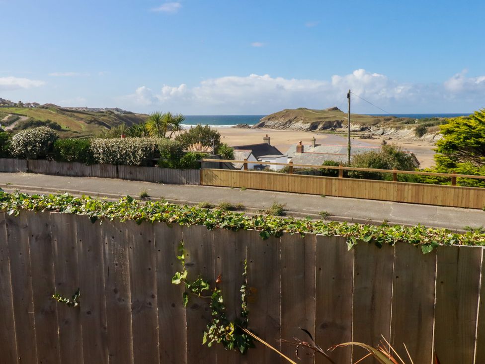 View of the beach and ocean from a fence at Mermaid Gaze in Newquay