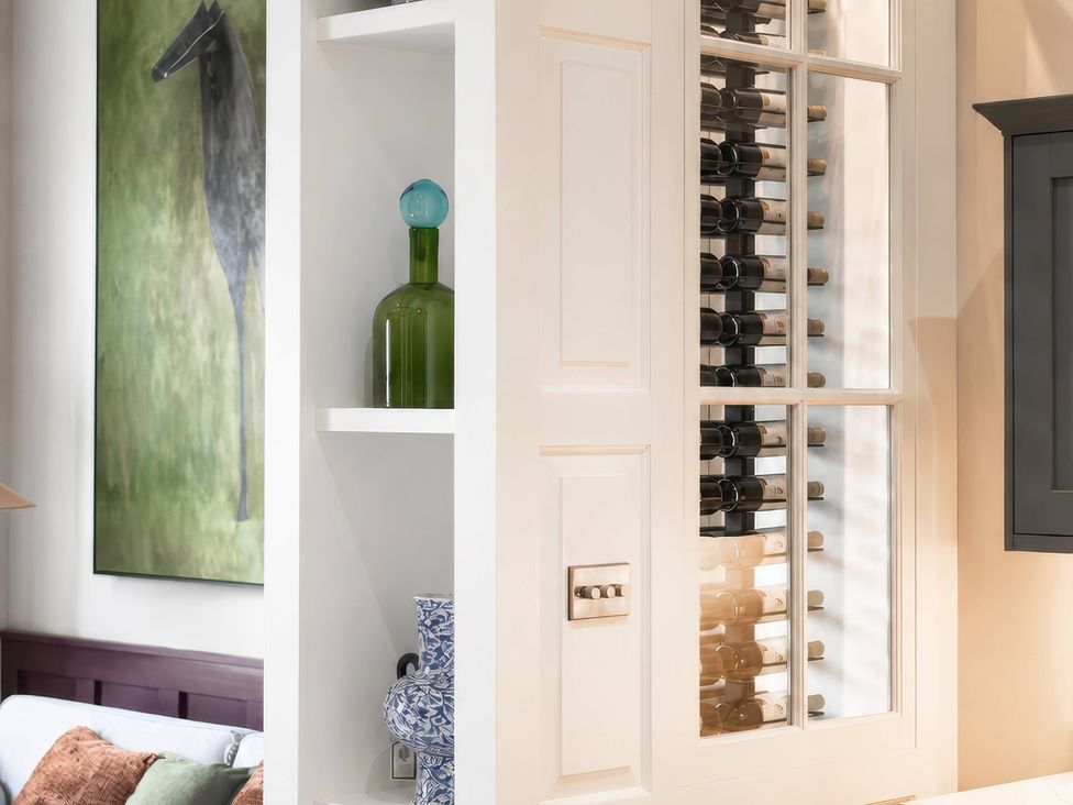 A living room with a wine cooler and decorative items at Apt.4 in York