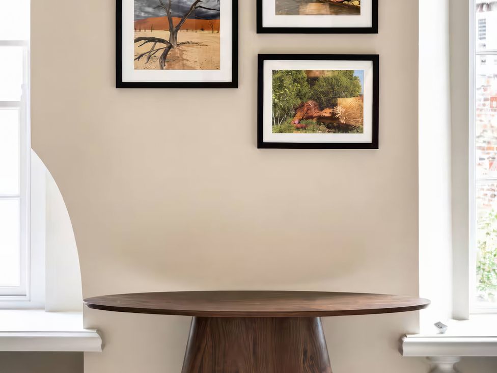 A table with framed artwork on the wall at Apt.4 in York