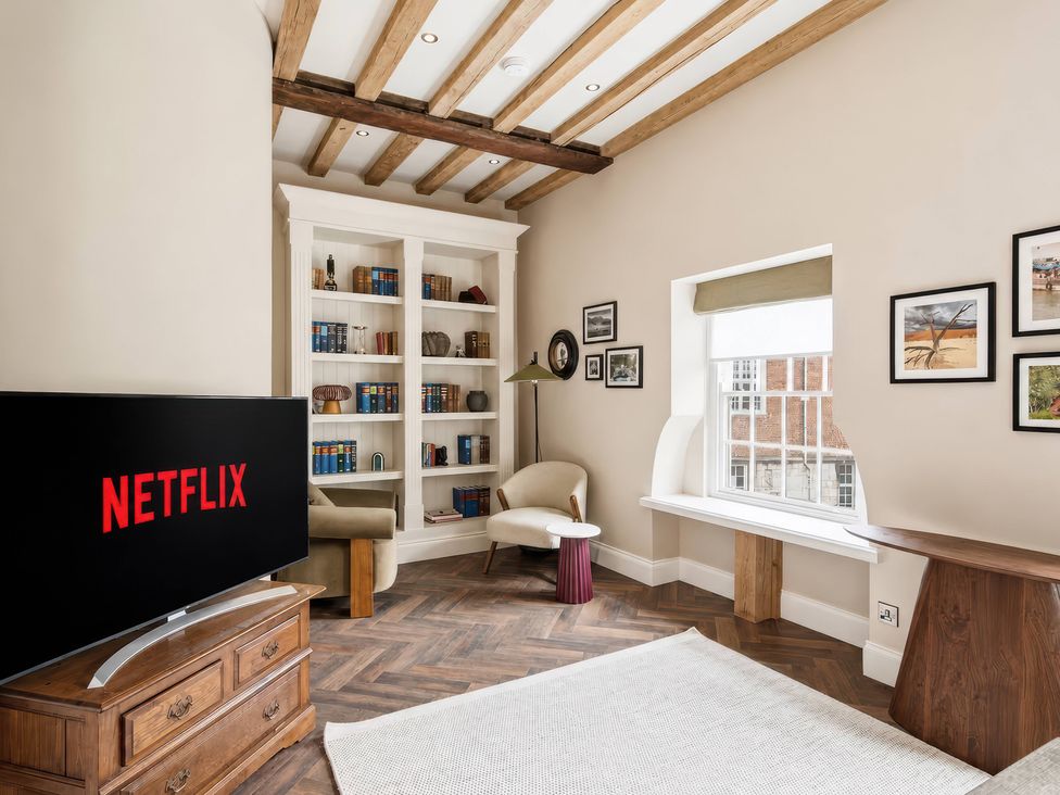 A living room with a television and bookshelf at Apt.4 in York