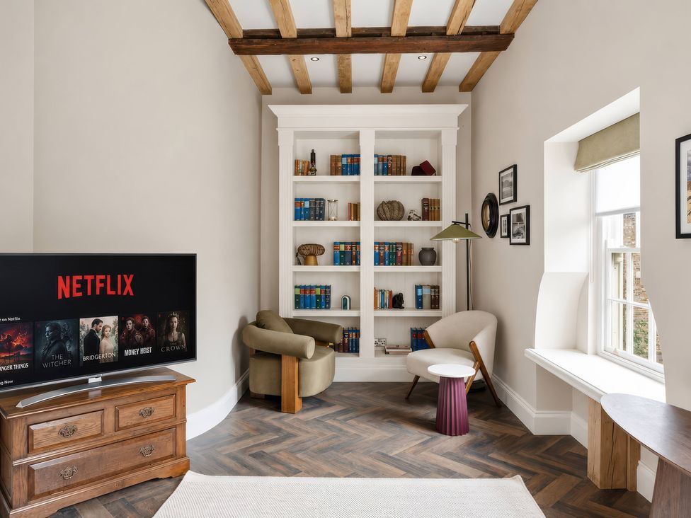 A living room with a television and bookshelf at Apt.4 in York