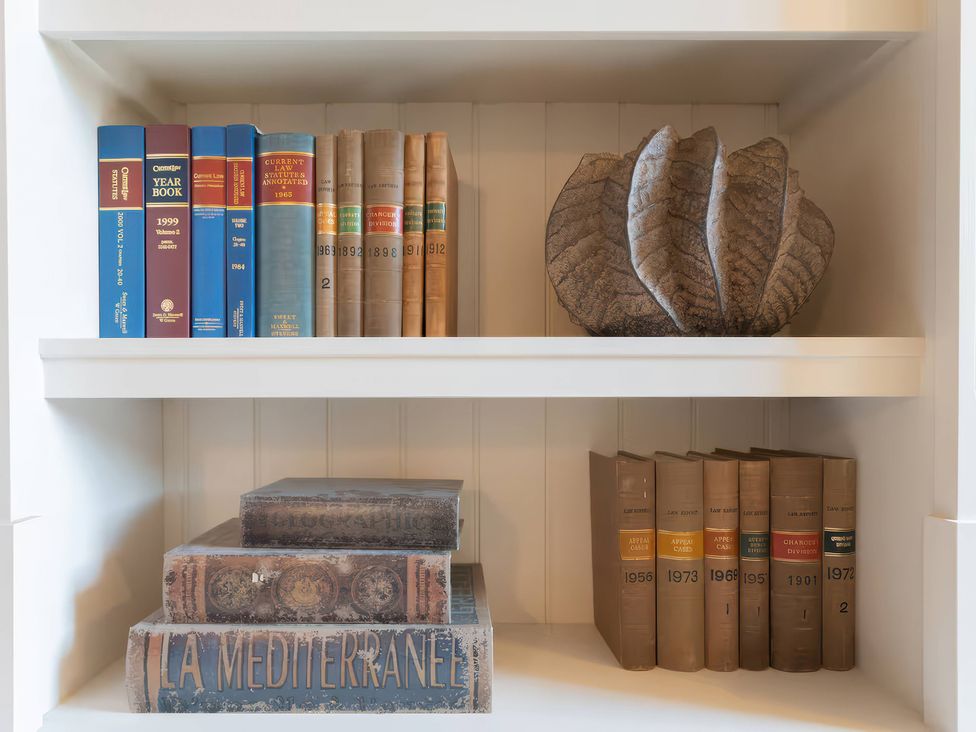 A shelf with various books and a decorative object at Apt.4 in York