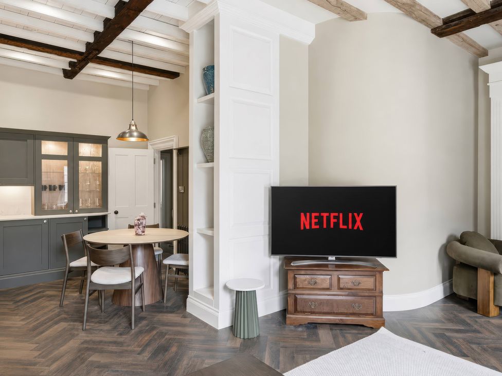 A living room with a television and dining area at Apt.4 in York