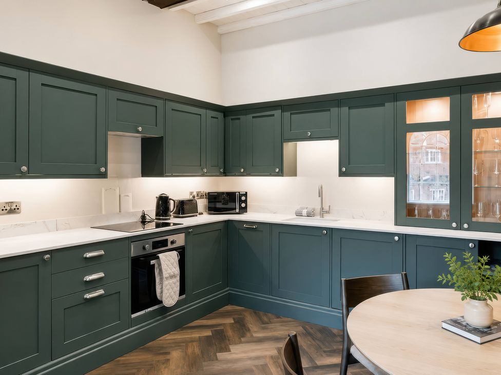 A kitchen with cabinets and appliances at Apt.4 York