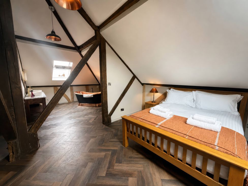 A bedroom with a bed and a bathtub at Apt.4 in York