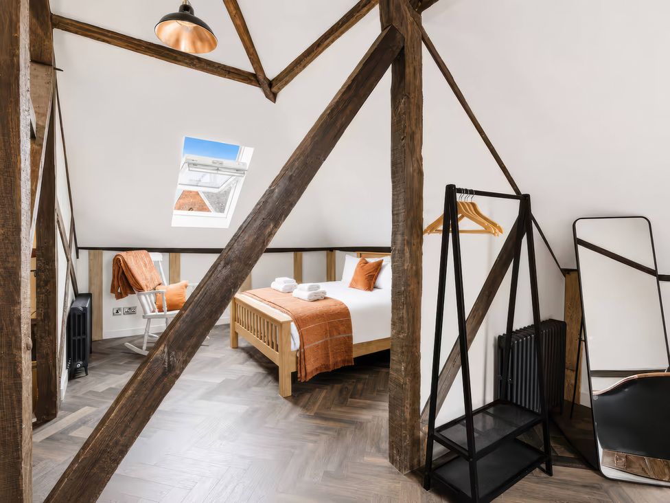 A bedroom with a bed and a clothes rack at Apt.4 in York