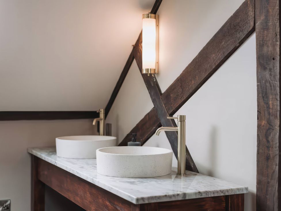 A bathroom with two sinks and a light fixture at Apt.4 in York