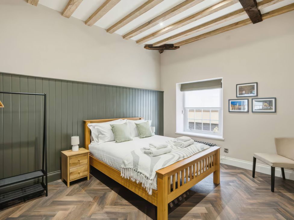 A bedroom with a bed and clothing rack at Apt.4 in York