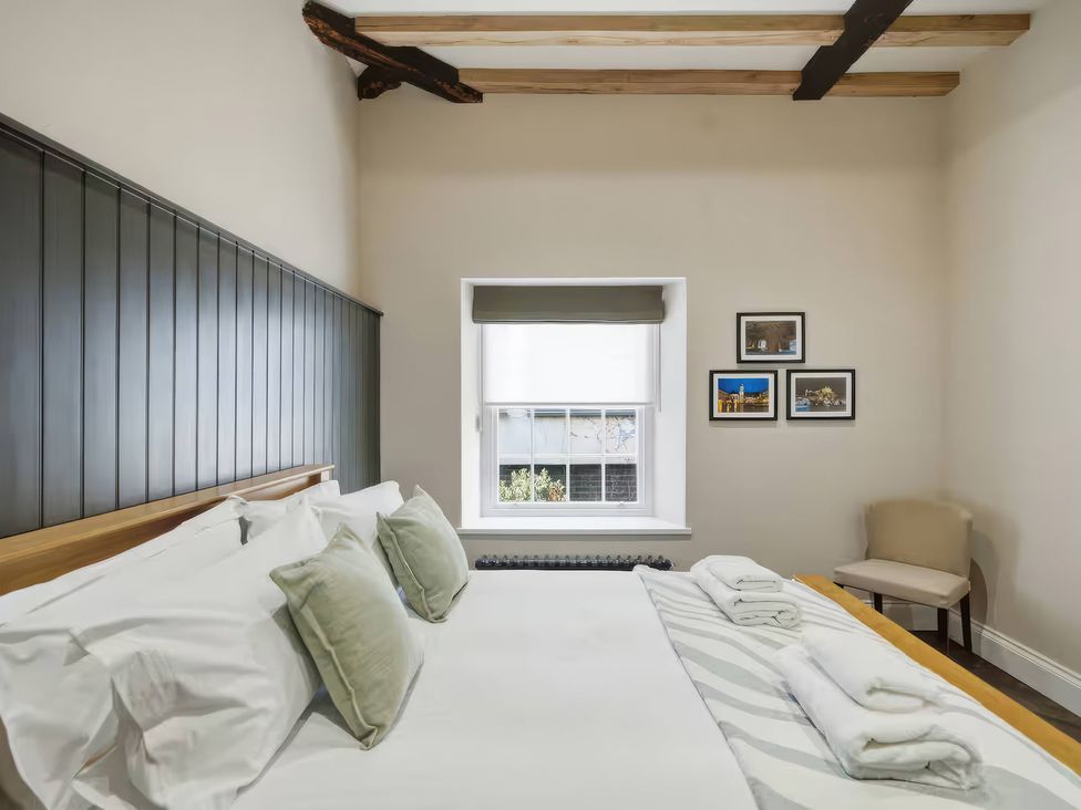 A bedroom with a bed and chair at Apt.4 in York