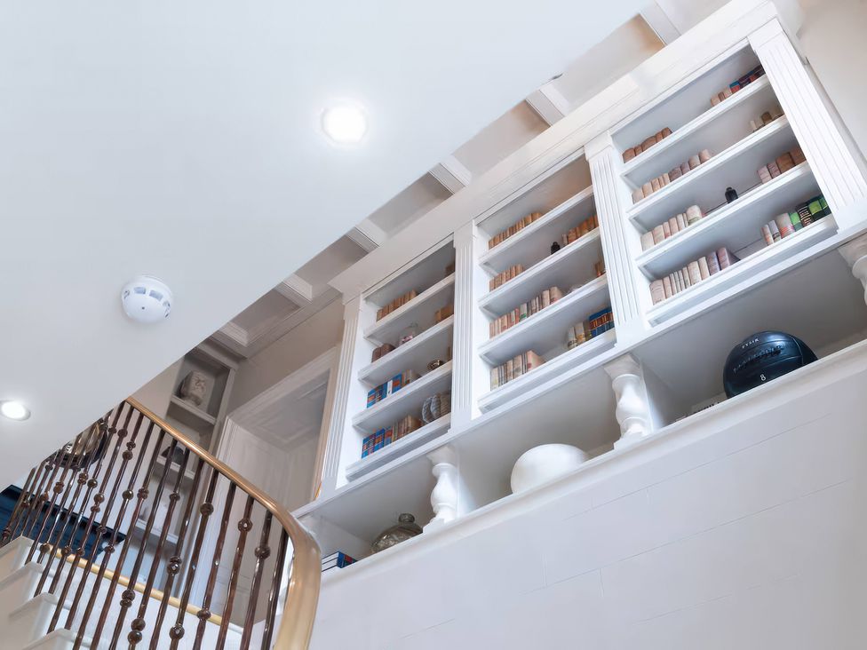 A staircase leading to shelves with books and decorative objects at Apt.4 in York