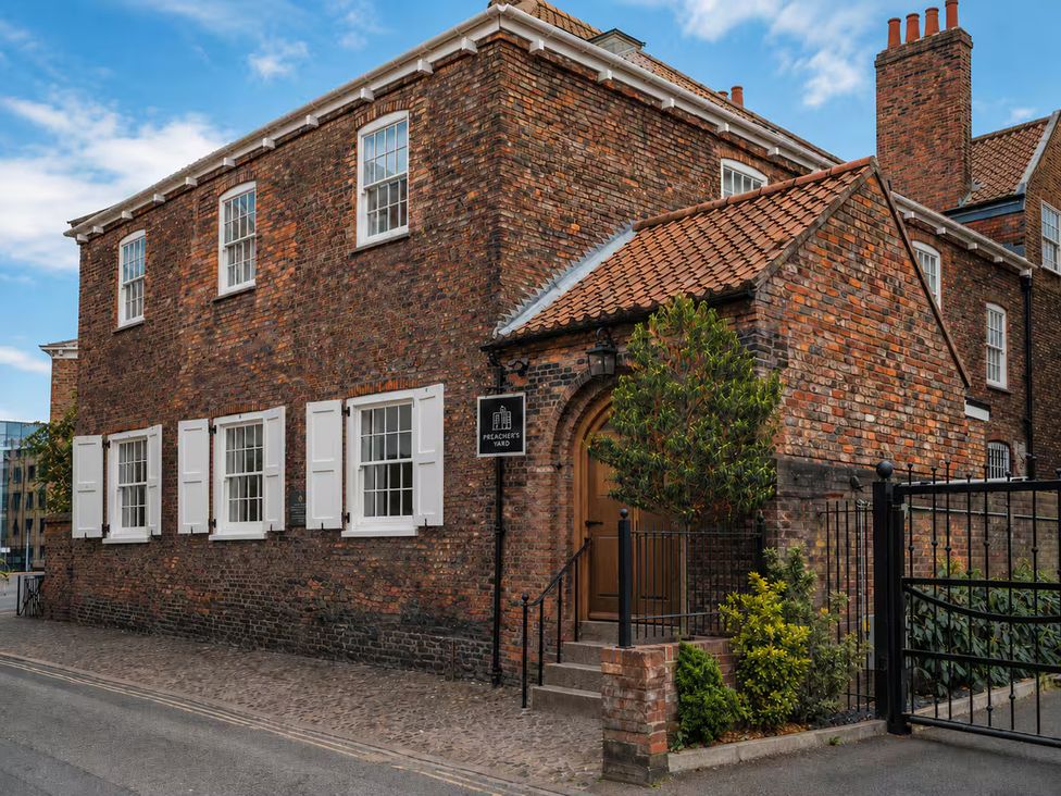A building with brick walls and white windows at Preachers Yard in York