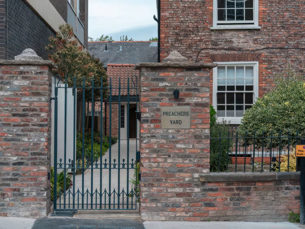 A gated entrance with a sign at Preachers Yard in York